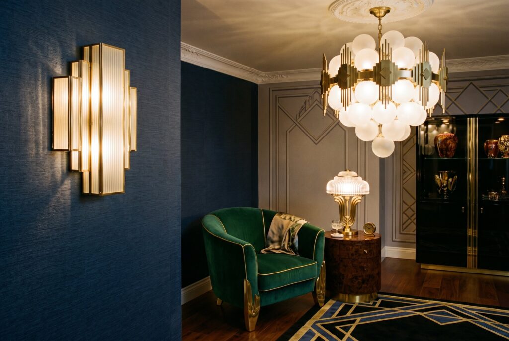 Sculptural Art Deco lighting with globe chandeliers and velvet seating in luxury lounge. 