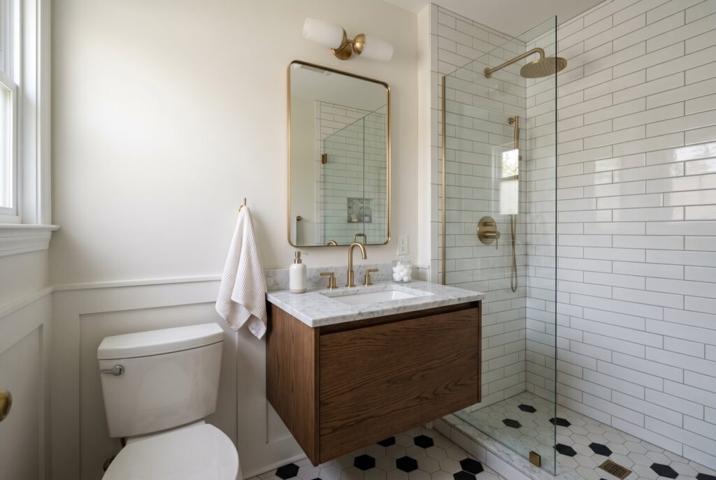 Small bathroom remodel trends 2026 with floating vanity and oversized shower tile. 