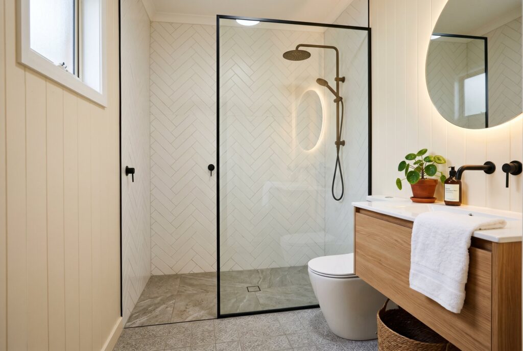 Open shower screen instead of full enclosure in compact modern bathroom layout. 