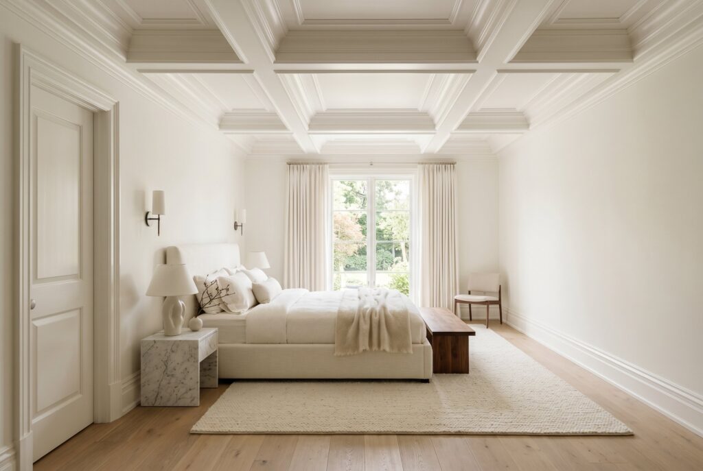 Color drenched white bedroom with matching walls, trim, and ceiling panel molding.