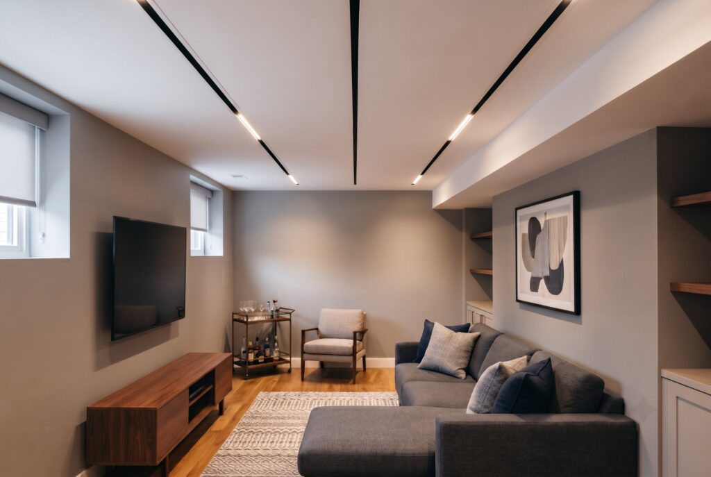 Infinity flush ceiling with concealed vents and recessed lighting in modern basement.