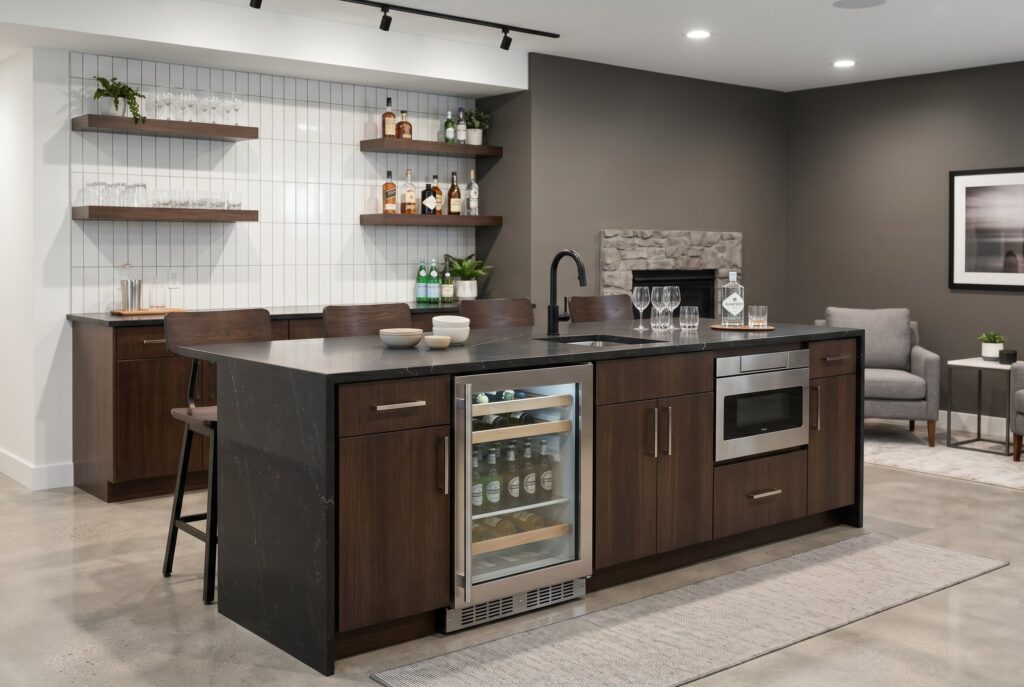 Basement kitchenette island with beverage fridge, microwave drawer, and open shelving. 