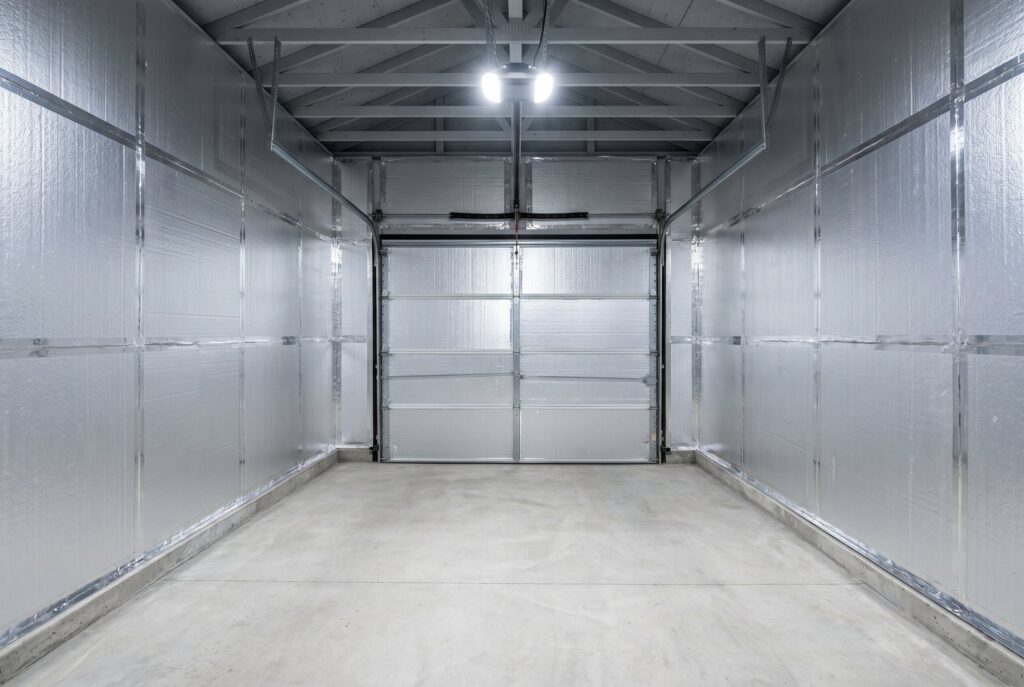 Insulated garage interior with foam board wall panels and sealed garage door system. 