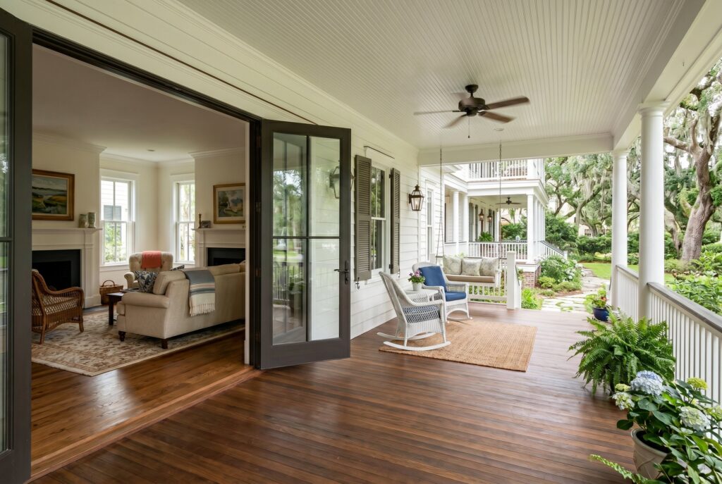 Flush indoor outdoor threshold connecting living room to wrap around porch lounge area. 