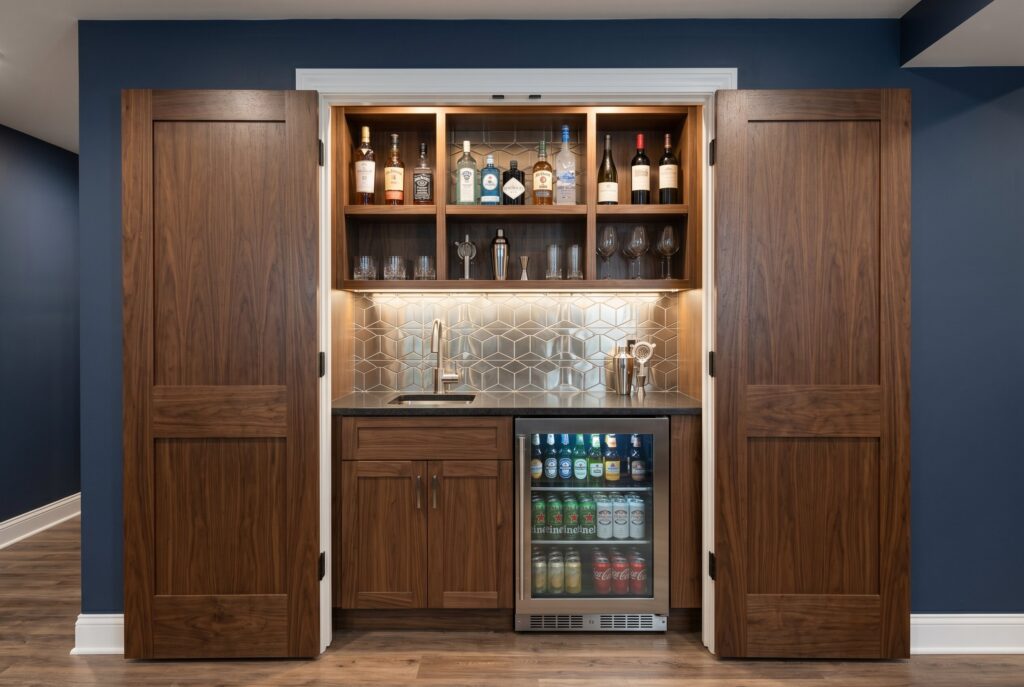 Hidden closet bar with pocket doors, beverage fridge, and built in bottle storage. 