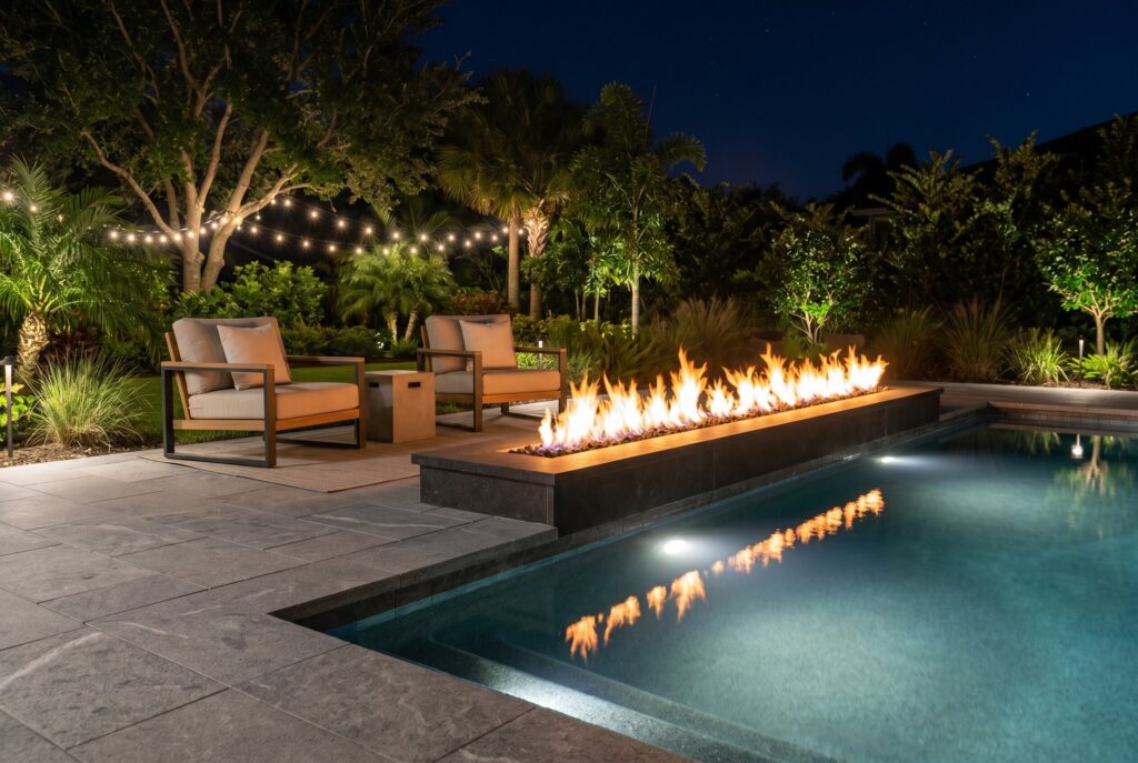 Poolside linear fire feature with modern seating and luxury resort style landscaping.
