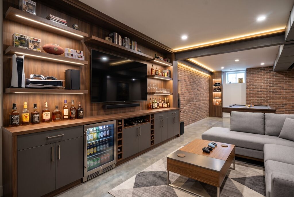 One wall gaming and dry bar setup with built in entertainment center and sectional seating.