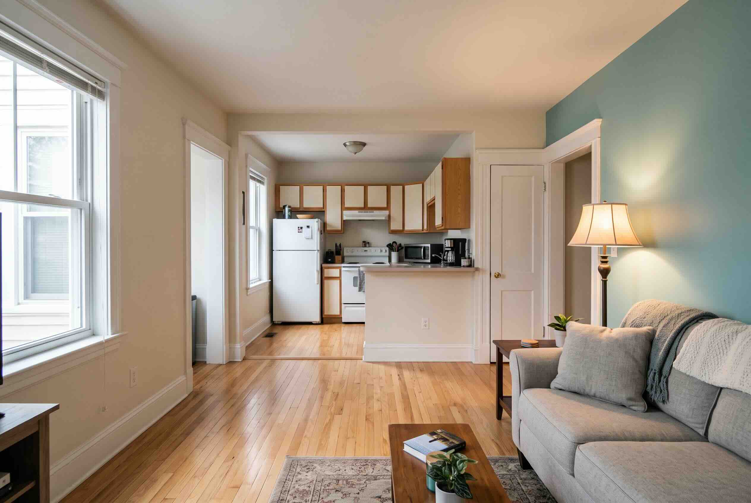 An open apartment layout providing a clear view from the living area directly into the adjacent kitchen.