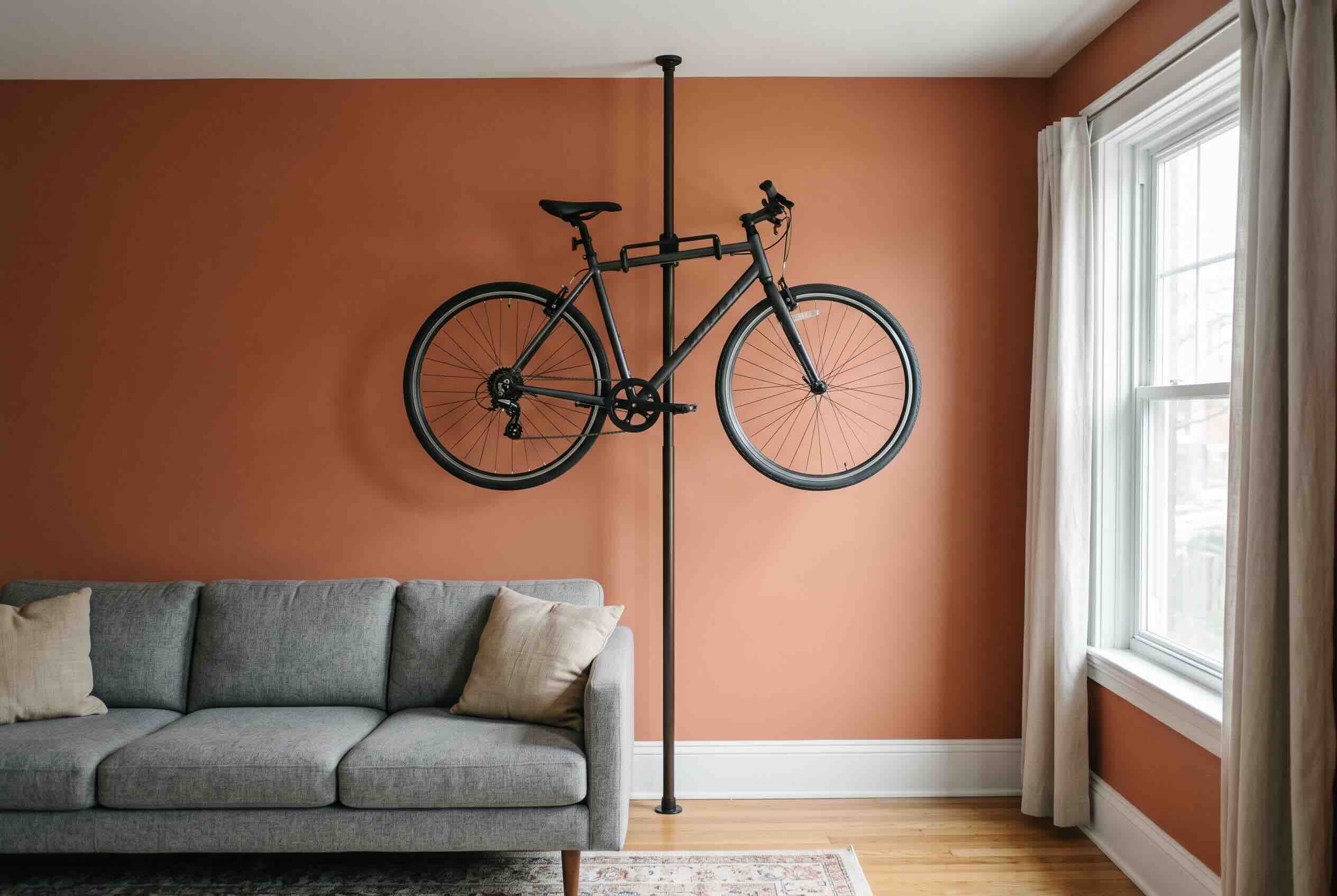 Storing a bicycle horizontally on a tension pole mounted between the floor and ceiling.